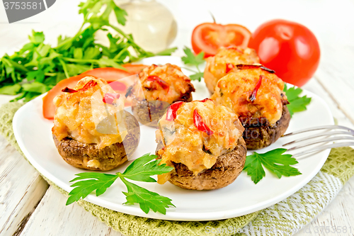 Image of Champignons stuffed meat and pepper in white plate on board