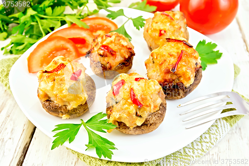 Image of Champignons stuffed meat in white plate on green napkin