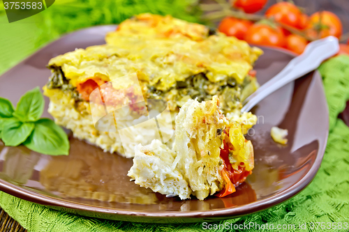 Image of Pie potato with tomato and fork on board