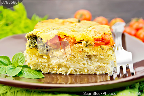 Image of Pie potato with tomato and cheese on board