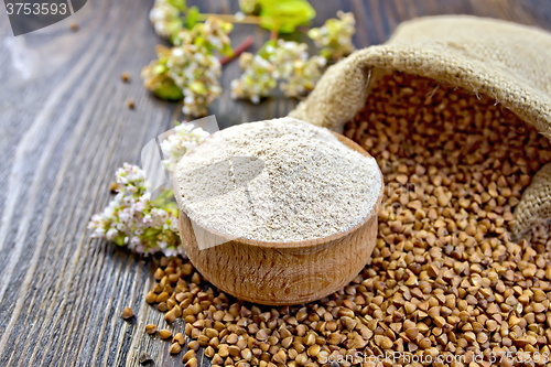 Image of Flour buckwheat in bowl with cereals and flower on board