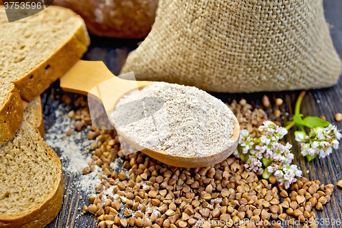 Image of Flour buckwheat in spoon with cereals and flower on board