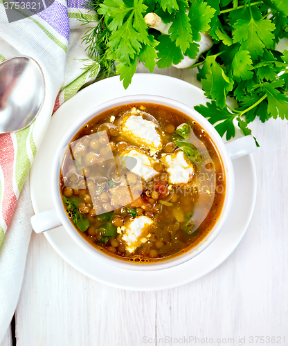 Image of Soup lentil with spinach and cheese on board top