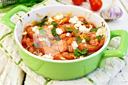 Image of Shrimp and tomatoes with feta in pan on board
