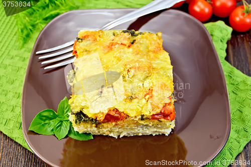 Image of Pie potato with tomato on dark board