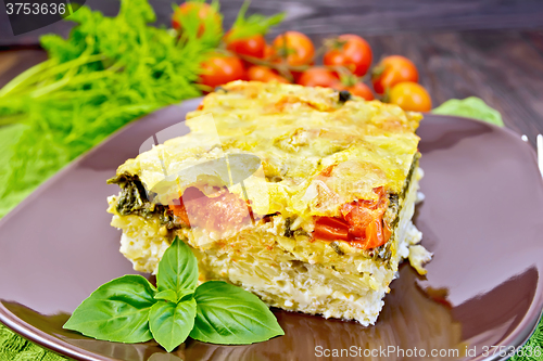 Image of Pie potato with tomato and cheese on dark board