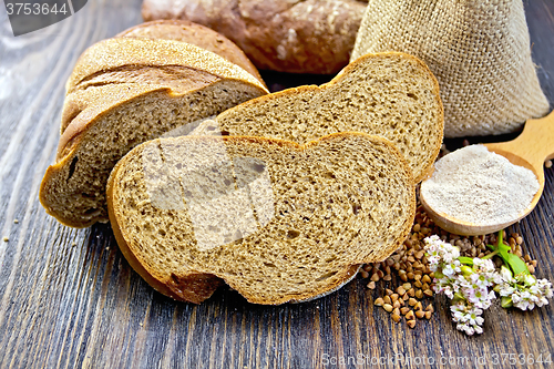 Image of Bread buckwheat with cereals and flower on dark board