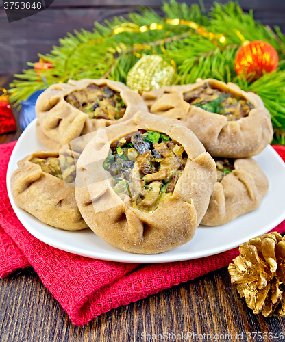 Image of Carols in dish with mushrooms and Christmas decorations on board