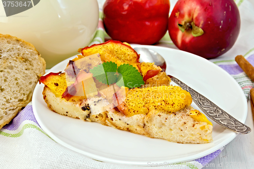 Image of Pudding from bread and peaches with milk on light board