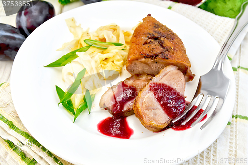 Image of Duck breast whole cabbage and green onions in plate