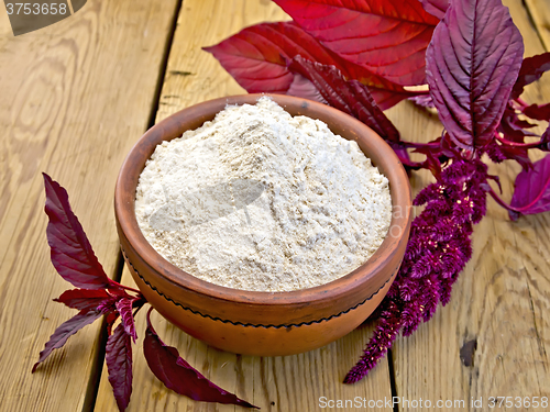 Image of Flour amaranth in clay bowl on board with flower