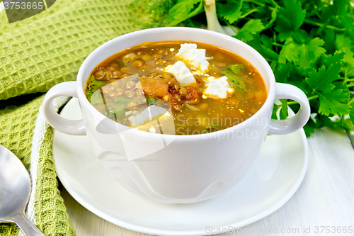 Image of Soup lentil with spinach and cheese on board