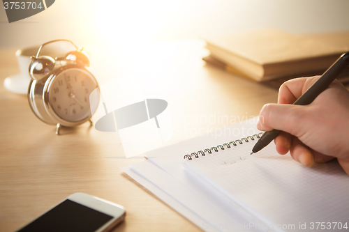 Image of The male hand with a pen