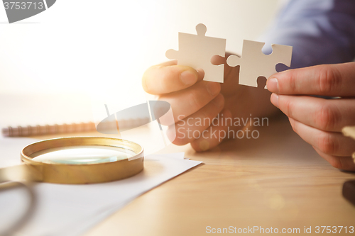 Image of Building a business success. The hands with puzzles