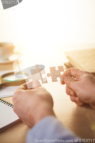 Image of Building a business success. The hands with puzzles