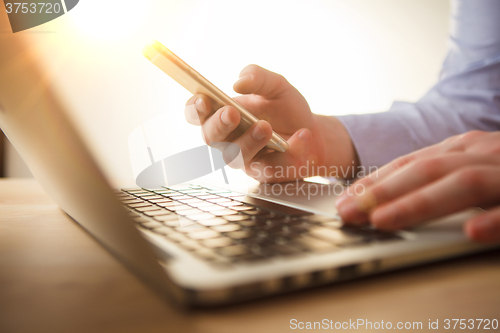 Image of The male hand holding a phone 