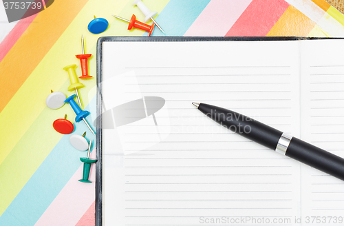 Image of Notepad with pen and pushpins