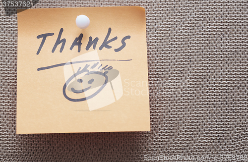 Image of Thanks written on a sticky note