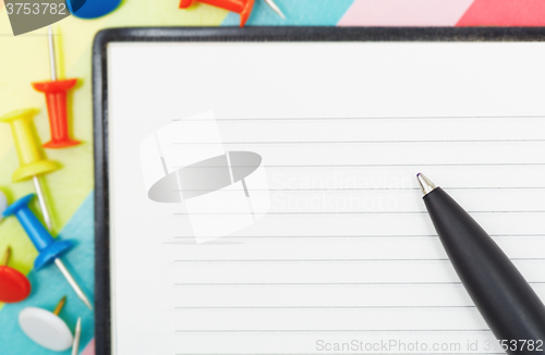 Image of Notepad with pen and pushpins