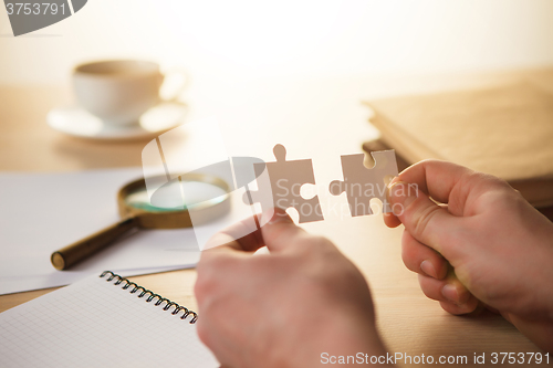 Image of Building a business success. The hands with puzzles