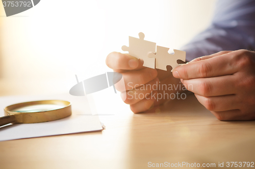 Image of Building a business success. The hands with puzzles