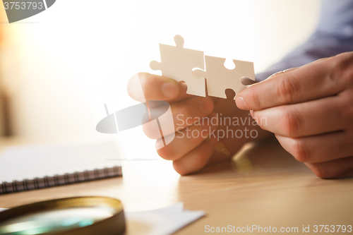 Image of Building a business success. The hands with puzzles