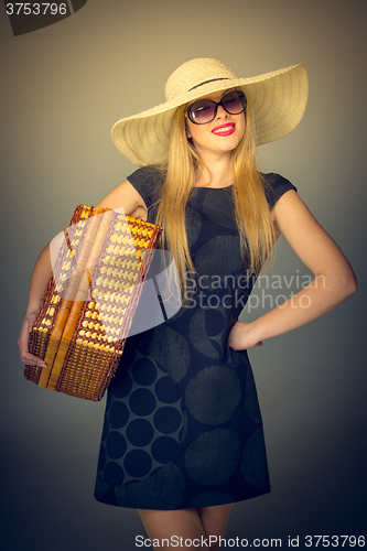 Image of The traveler woman standing with retro suitcase 