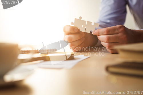 Image of Building a business success. The hands with puzzles