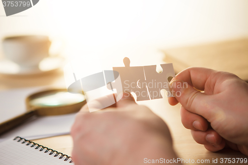 Image of Building a business success. The hands with puzzles