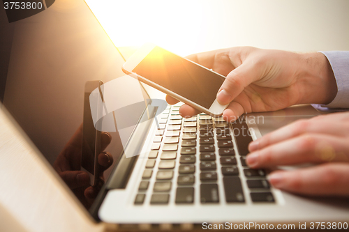 Image of The male hand holding a phone 