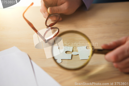 Image of Building a business success. The hands with puzzles