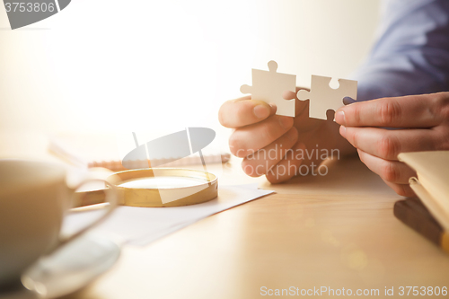 Image of Building a business success. The hands with puzzles