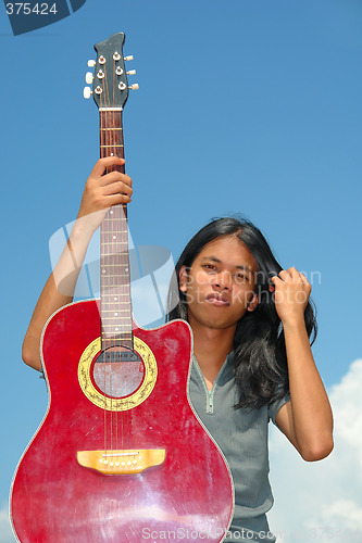 Image of Asian teen with guitar