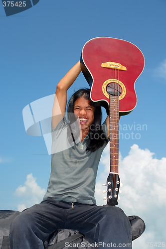 Image of Asian cheering with guitar
