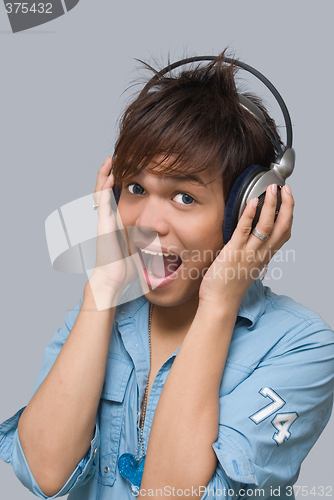 Image of Cheering boy with headphones