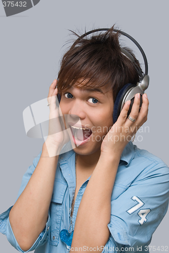 Image of Cheering boy with headphones