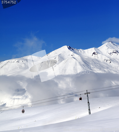 Image of Winter snowy mountains and cable car at nice day