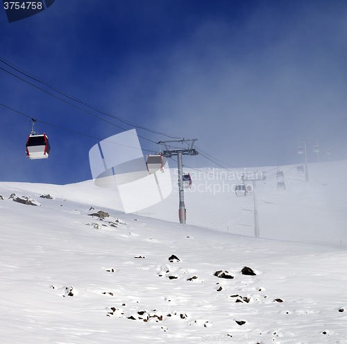 Image of Gondola lifts and ski slope in mist