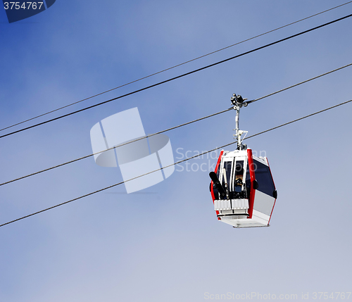 Image of Gondola lift with ski and snowboards