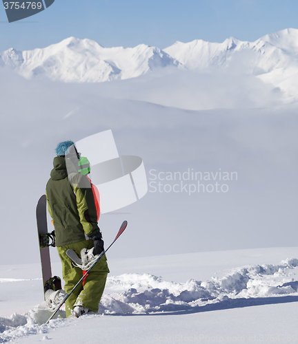 Image of Snowboarders on off-piste slope after snowfall