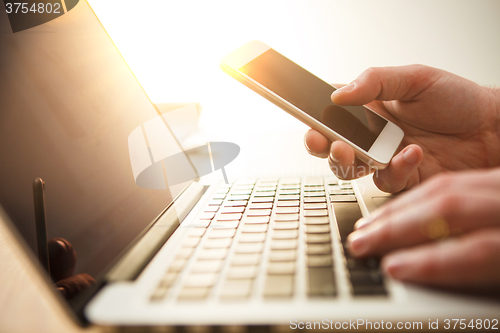 Image of The male hand holding a phone 
