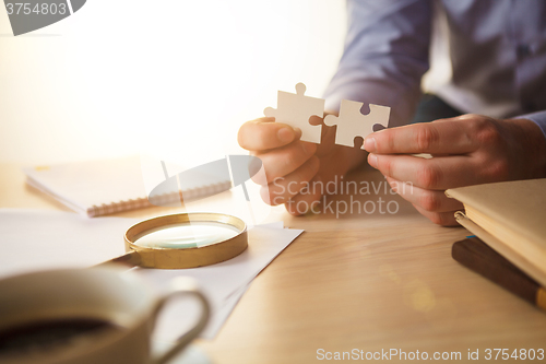 Image of Building a business success. The hands with puzzles