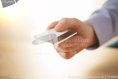 Image of The male hand showing credit card