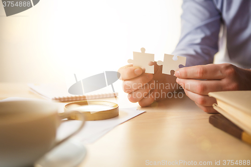 Image of Building a business success. The hands with puzzles