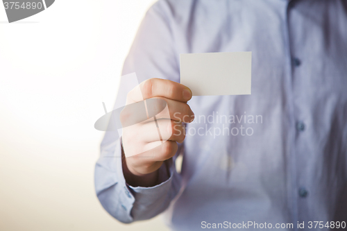 Image of Man holding white business card 