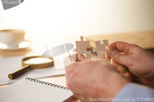 Image of Building a business success. The hands with puzzles