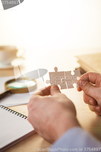 Image of Building a business success. The hands with puzzles