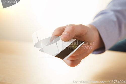 Image of The male hand showing credit card