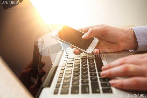 Image of The male hand holding a phone 