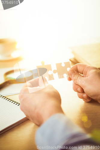 Image of Building a business success. The hands with puzzles